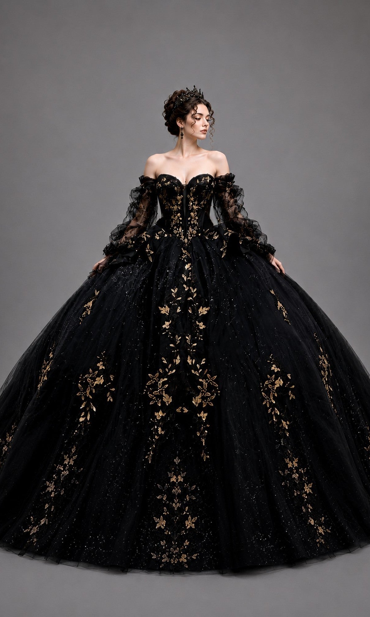A woman wearing the Quinceanera Dress 5190 by Dancing Queen in black, featuring intricate gold leaf appliques and sheer sleeves, poses against a plain gray background—a stunning choice for a truly memorable celebration.